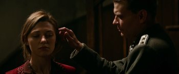 Movie still from “Overlord” (2018), directed by Julius Avery – A man putting lipstick on a woman's face; Close Up shot, Over the shoulder angle