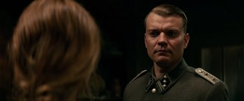 Movie still from “Overlord” (2018), directed by Julius Avery – A man in a military uniform looking into a mirror; Close Up shot, Over the shoulder angle