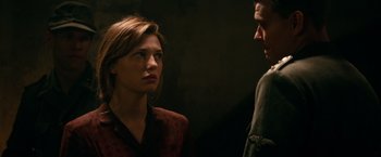Movie still from “Overlord” (2018), directed by Julius Avery – A man and a woman standing next to each other; Close Up shot, Over the shoulder angle