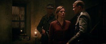 Movie still from “Overlord” (2018), directed by Julius Avery – A group of people standing next to each other in a room; Medium shot, Over the shoulder angle