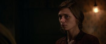 Movie still from “Overlord” (2018), directed by Julius Avery – A young woman is looking into the camera; Close Up shot, Over the shoulder angle