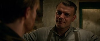 Movie still from “Overlord” (2018), directed by Julius Avery – A man in a gray shirt is looking at a woman; Close Up shot, Over the shoulder angle