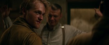 Movie still from “Overlord” (2018), directed by Julius Avery – Two men standing next to each other in a dark room; Close Up shot, Over the shoulder angle