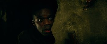 Movie still from “Overlord” (2018), directed by Julius Avery – A man with his mouth wide open looking at the camera; Close Up shot, Overhead angle