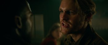 Movie still from “Overlord” (2018), directed by Julius Avery – A person with a beard; Close Up shot, Over the shoulder angle