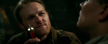 Movie still from “Overlord” (2018), directed by Julius Avery – A person holding a drink in his hand; Close Up shot, Over the shoulder angle
