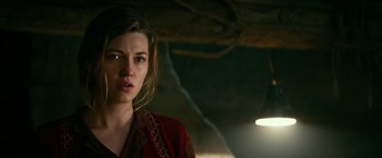 Movie still from “Overlord” (2018), directed by Julius Avery – A woman in a red jacket is looking at the camera; Close Up shot, Over the shoulder angle