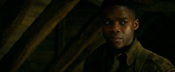 Movie still from “Overlord” (2018), directed by Julius Avery – A person wearing a shirt; Close Up shot, Over the shoulder angle