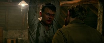 Movie still from “Overlord” (2018), directed by Julius Avery – A man with blood all over his face; Close Up shot, Over the shoulder angle