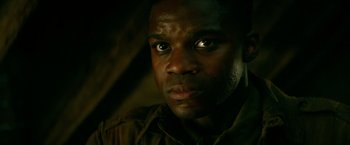 Movie still from “Overlord” (2018), directed by Julius Avery – A man's face in the dark; Close Up shot, Low angle