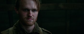 Movie still from “Overlord” (2018), directed by Julius Avery – A person with a beard; Close Up shot, Low angle