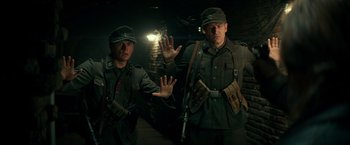 Movie still from “Overlord” (2018), directed by Julius Avery – A couple of men standing next to each other; Medium shot, Low angle