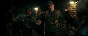 Movie still from “Overlord” (2018), directed by Julius Avery – A couple of men standing next to each other; Medium shot, Low angle