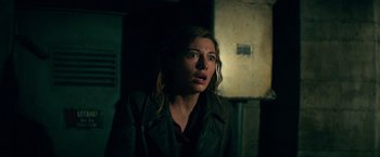 Movie still from “Overlord” (2018), directed by Julius Avery – A woman in a leather jacket looking up at the ceiling; Close Up shot, Low angle