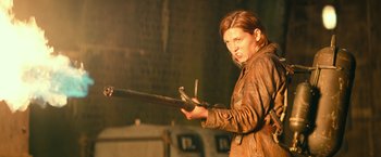 Movie still from “Overlord” (2018), directed by Julius Avery – A man holding a sword in his hands; Medium shot, Low angle