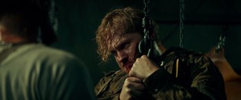Movie still from “Overlord” (2018), directed by Julius Avery – A person holding a chain; Close Up shot, Over the shoulder angle