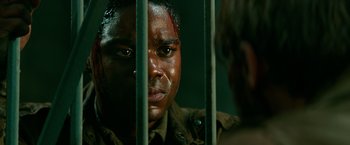 Movie still from “Overlord” (2018), directed by Julius Avery – A person in a jail cell; Close Up shot, Over the shoulder angle