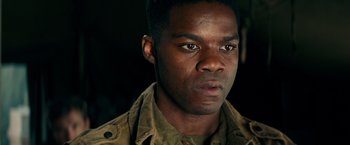 Movie still from “Overlord” (2018), directed by Julius Avery – A person wearing a military uniform; Close Up shot, Over the shoulder angle