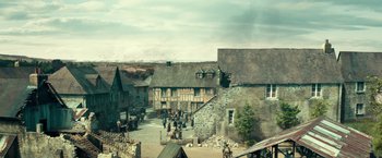 Movie still from “Overlord” (2018), directed by Julius Avery – An image of an old town with a lot of people in it; Extreme Wide shot, High angle