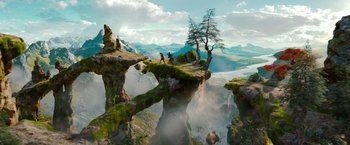 Movie still from “Oz the Great and Powerful” (2013), directed by Sam Raimi – A couple of people standing on top of a cliff; Extreme Wide shot, High angle