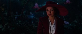 Movie still from “Oz the Great and Powerful” (2013), directed by Sam Raimi – A woman in a red coat and a red hat; Close Up shot, Over the shoulder angle