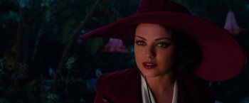 Movie still from “Oz the Great and Powerful” (2013), directed by Sam Raimi – A woman wearing a red hat and a red coat; Close Up shot, Over the shoulder angle
