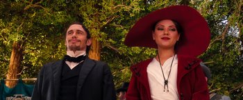 Movie still from “Oz the Great and Powerful” (2013), directed by Sam Raimi – A man and a woman dressed up in costumes; Medium shot, Low angle