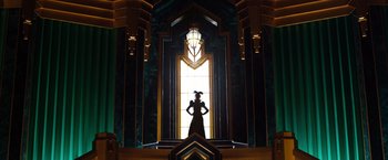 Movie still from “Oz the Great and Powerful” (2013), directed by Sam Raimi – A woman standing in front of a stained glass window; Wide shot, Low angle