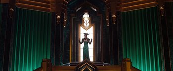Movie still from “Oz the Great and Powerful” (2013), directed by Sam Raimi – A woman standing in front of a stained glass window; Wide shot, Low angle