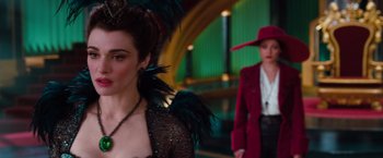 Movie still from “Oz the Great and Powerful” (2013), directed by Sam Raimi – A woman in a black dress and a woman in a red jacket; Close Up shot, Over the shoulder angle