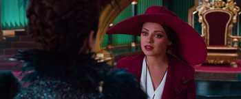 Movie still from “Oz the Great and Powerful” (2013), directed by Sam Raimi – A woman wearing a red hat talking to another woman; Close Up shot, Over the shoulder angle