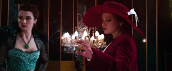 Movie still from “Oz the Great and Powerful” (2013), directed by Sam Raimi – A woman in a red coat and a red hat; Medium shot, Low angle