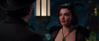 Movie still from “Oz the Great and Powerful” (2013), directed by Sam Raimi – A woman in a black dress and a man in a green hat; Close Up shot, Over the shoulder angle