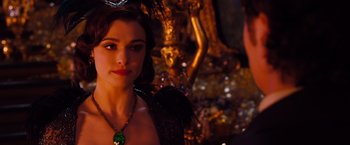 Movie still from “Oz the Great and Powerful” (2013), directed by Sam Raimi – A person wearing a necklace; Close Up shot, Over the shoulder angle