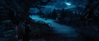 Movie still from “Oz the Great and Powerful” (2013), directed by Sam Raimi – A dark forest with a full moon in the background; Extreme Wide shot, High angle