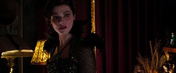 Movie still from “Oz the Great and Powerful” (2013), directed by Sam Raimi – A person wearing a dress; Close Up shot, Over the shoulder angle