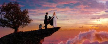 Movie still from “Oz the Great and Powerful” (2013), directed by Sam Raimi – A man and a woman standing on top of a cliff; Wide shot, Low angle
