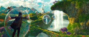 Movie still from “Oz the Great and Powerful” (2013), directed by Sam Raimi – A woman in a white dress standing in front of a waterfall; Extreme Wide shot, High angle