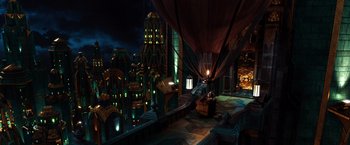 Movie still from “Oz the Great and Powerful” (2013), directed by Sam Raimi – An image of a scene in a city at night time; Extreme Wide shot, High angle