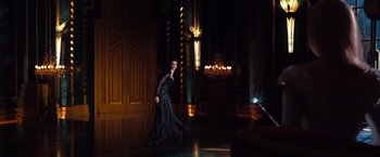 Movie still from “Oz the Great and Powerful” (2013), directed by Sam Raimi – A woman in a black dress in front of a chandelier; Wide shot, Low angle