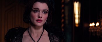 Movie still from “Oz the Great and Powerful” (2013), directed by Sam Raimi – A person wearing a necklace; Close Up shot, Over the shoulder angle