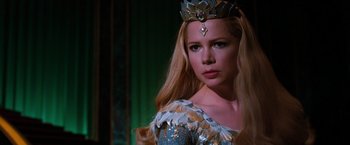 Movie still from “Oz the Great and Powerful” (2013), directed by Sam Raimi – A woman with long blonde hair wearing a crown; Close Up shot, Over the shoulder angle