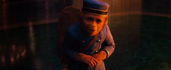 Movie still from “Oz the Great and Powerful” (2013), directed by Sam Raimi – A chimpanzee dressed as an air traffic controller; Medium shot, High angle