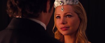 Movie still from “Oz the Great and Powerful” (2013), directed by Sam Raimi – A woman wearing a crown is looking at a man in a suit; Close Up shot, Over the shoulder angle