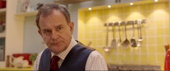 Movie still from “Paddington 2” (2017), directed by Paul King – A person wearing a tie; Close Up shot, Over the shoulder angle