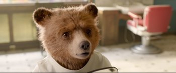 Movie still from “Paddington 2” (2017), directed by Paul King – A teddy bear wearing a white shirt and a brown shirt; Close Up shot, Low angle