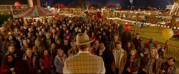 Movie still from “Paddington 2” (2017), directed by Paul King – A large group of people standing in front of a crowd; Wide shot, High angle