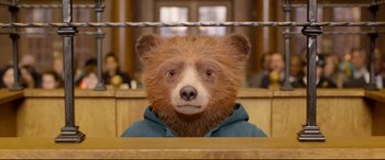 Movie still from “Paddington 2” (2017), directed by Paul King – A brown teddy bear wearing a blue hoodie; Close Up shot, High angle