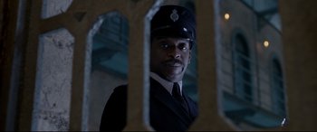 Movie still from “Paddington 2” (2017), directed by Paul King – A man in a police uniform looking at the camera; Close Up shot, Low angle