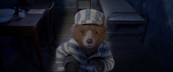 Movie still from “Paddington 2” (2017), directed by Paul King – A teddy bear wearing a striped shirt and hat; Close Up shot, High angle